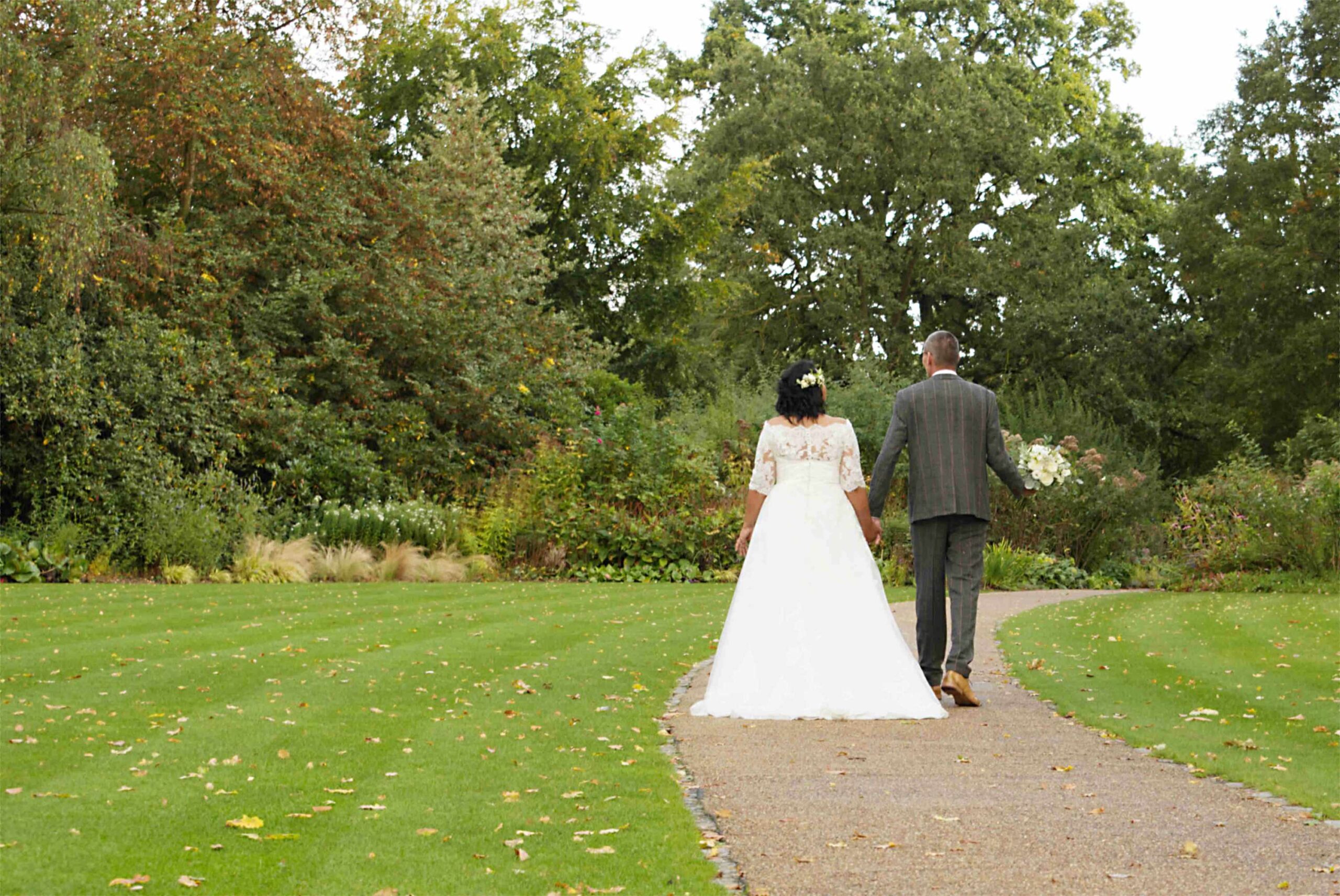 Logo elements ARROWS copyright Nadina Bee early autumn wedding photo of wedding couple walking away from the viewer