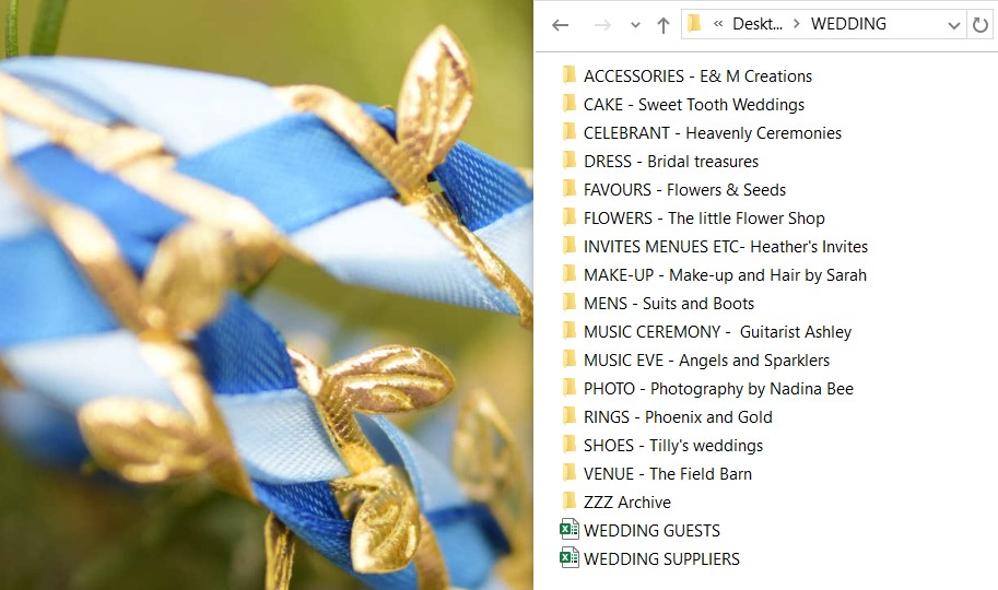 Logo elements ARROWS copyright Nadina Bee A screenshot showing a wedding planning folder that is organised by supplier type to help avoid wedding planning stress, also containing spreadsheets for capturing supplier and guest information, the folder sits next to a blue and gold coloured handfasting ribbon, copyright Nadina Bee