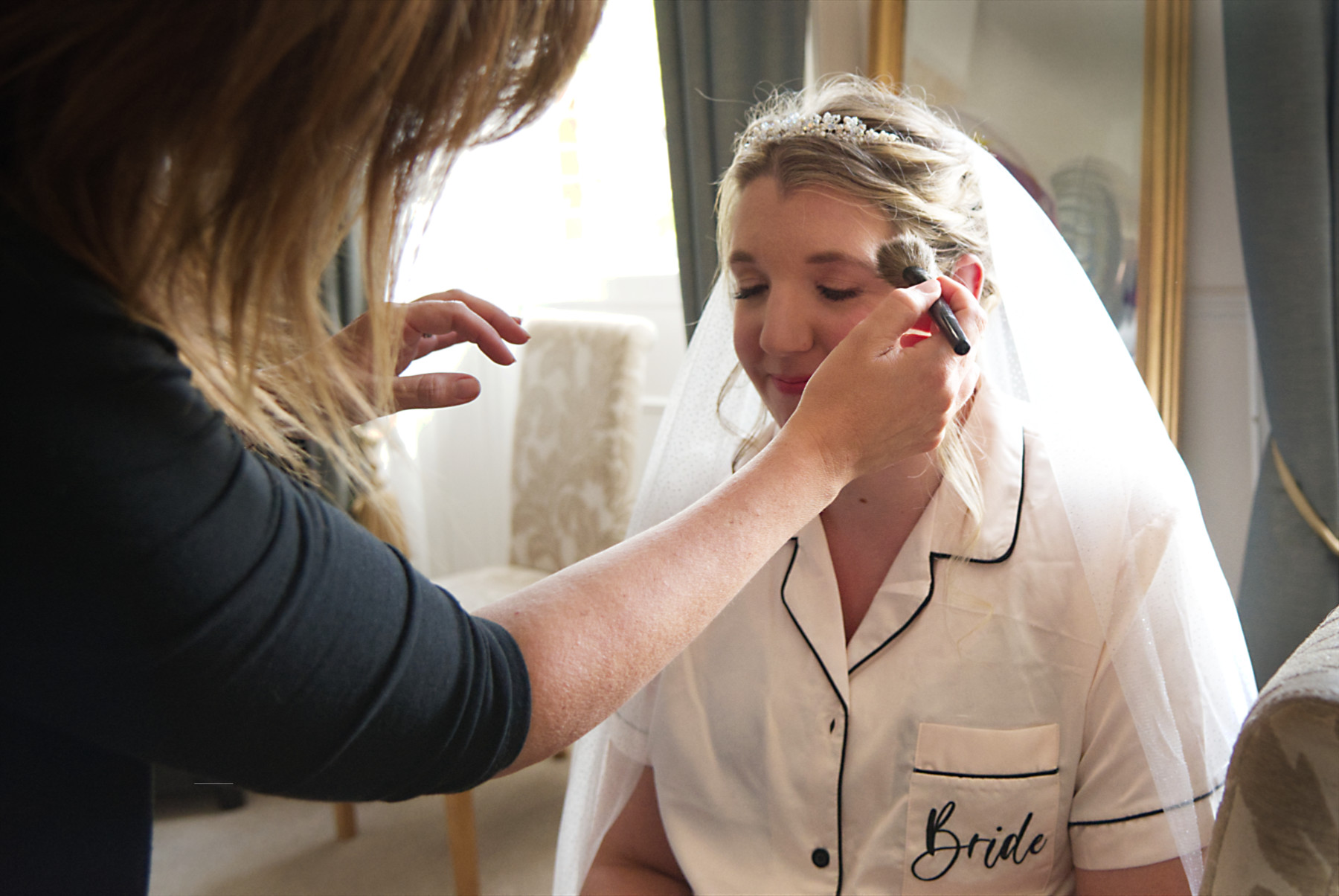 Photo of make-up artist getting the bride ready at Mill House Reading by Photography by Nadina Bee