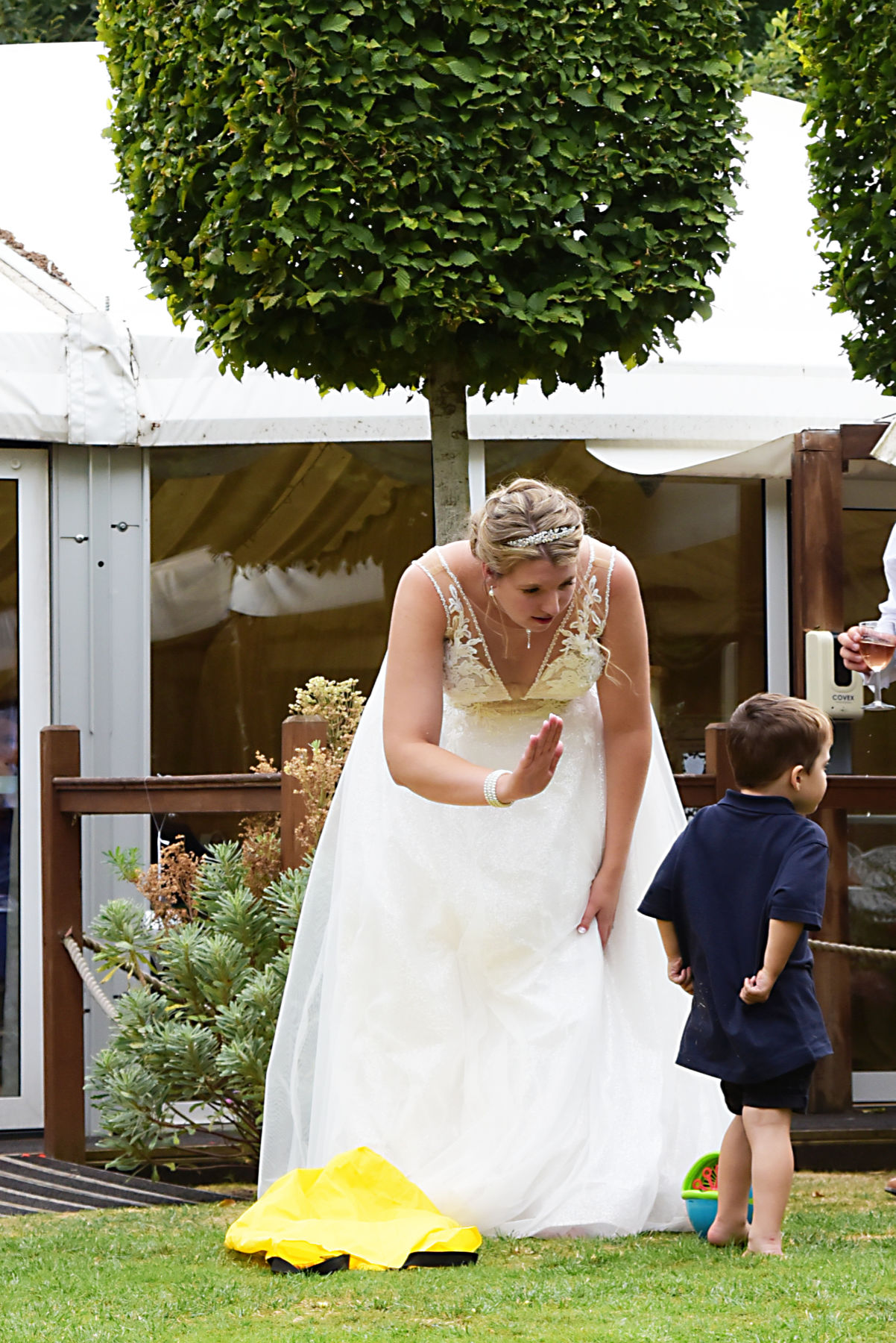 Bride giving small child high five at wedding at Mill House Reading by Wedding Photographer Nadina Bee Berkshire